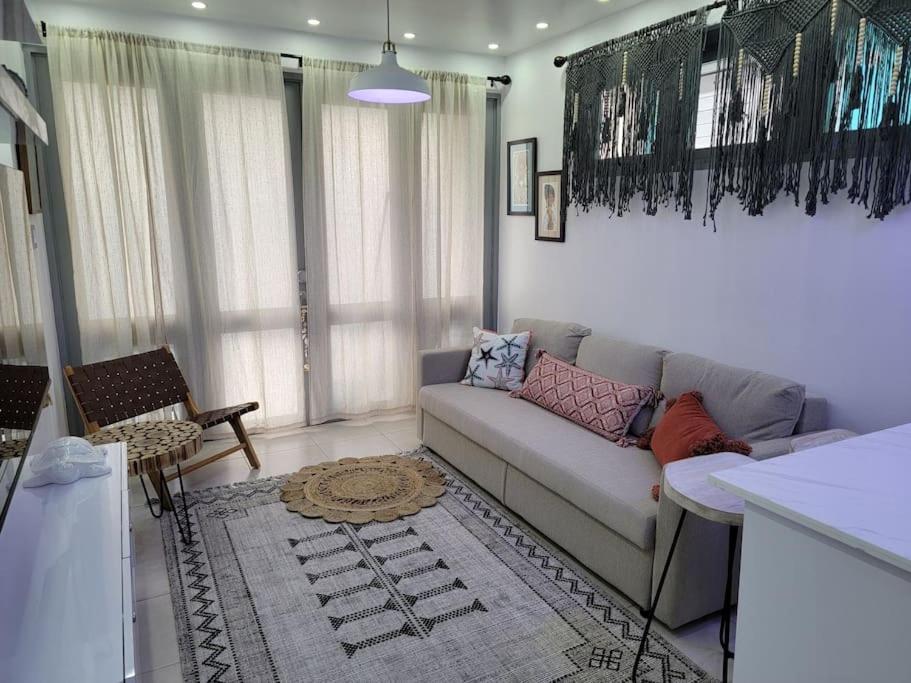 a living room with a couch and a table at The Palm Retreat Buye, Playa Buyé in El Cerro