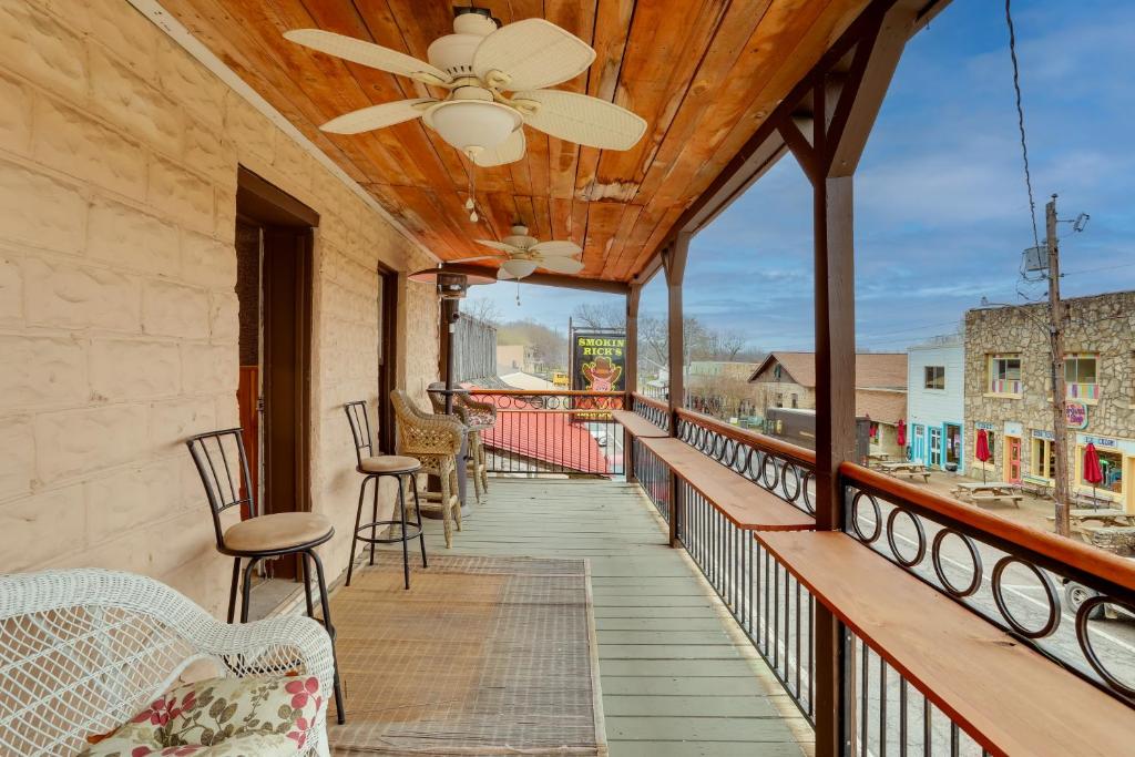 a balcony with chairs and a ceiling fan at Historic Hardy Home with Game Room on Main Street in Hardy