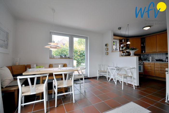 a kitchen and dining room with a table and chairs at Ferienhaus Friesenblick Ferienwohnung 1 in Wangerooge