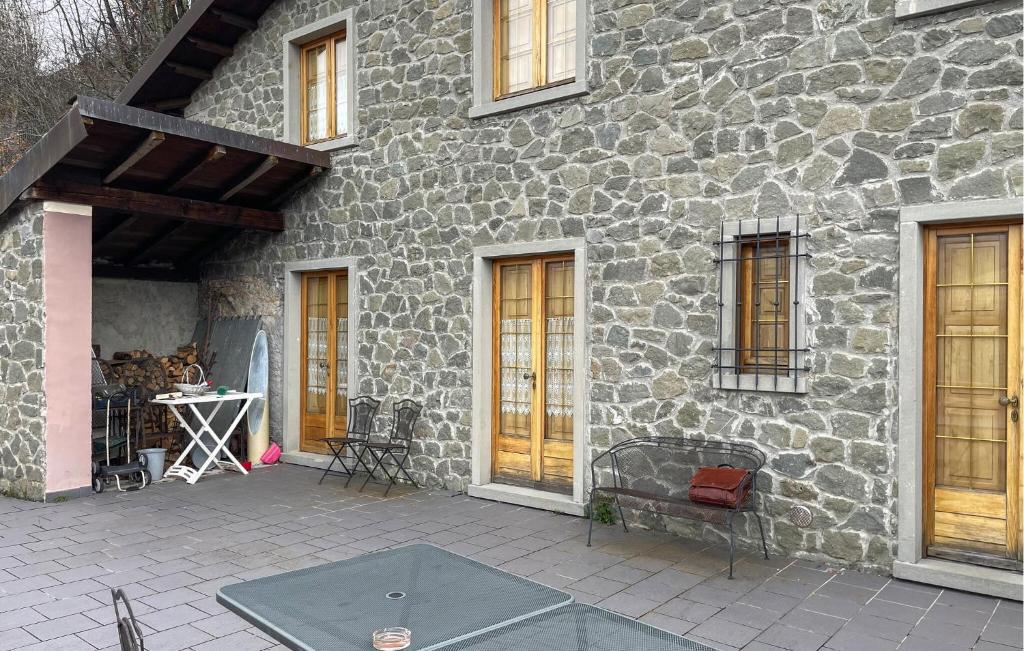- un bâtiment en pierre avec une table de ping-pong devant dans l'établissement Amazing Home In Comano With Kitchenette, à Comano