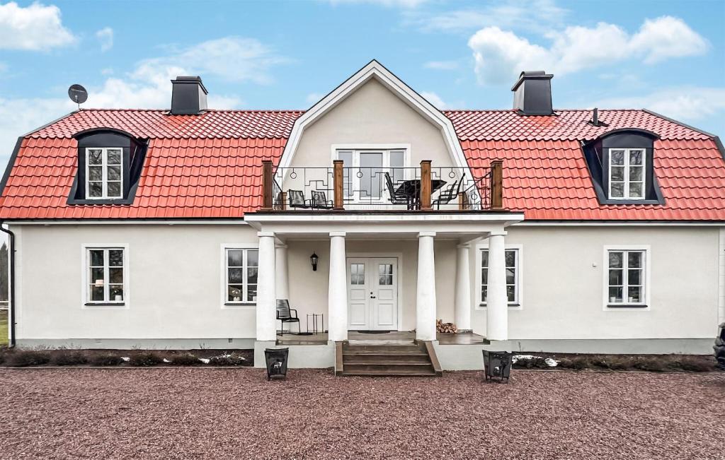 a white house with a red roof at 5 Bedroom Lovely Home In Ruda in Ruda