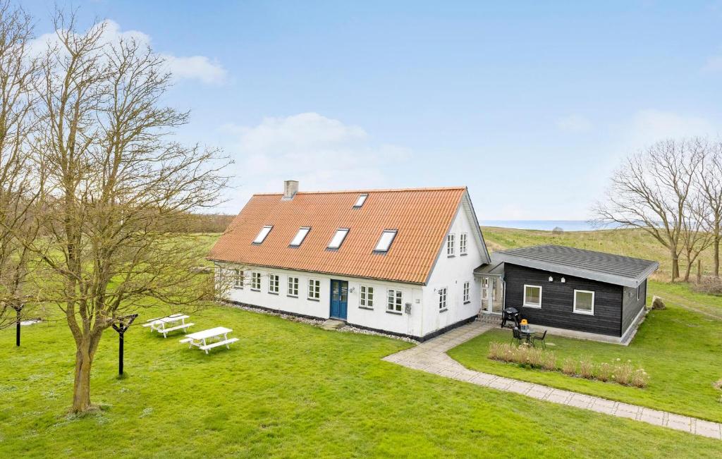 a large white house with an orange roof at 5 Bedroom Gorgeous Home In Bjørnø in Bjerne