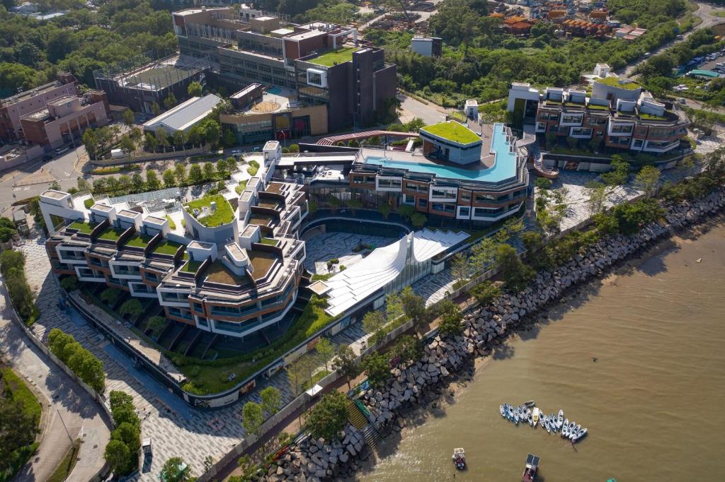 an aerial view of a large building next to the water at WM Hotel Hong Kong, Vignette Collection in Hong Kong