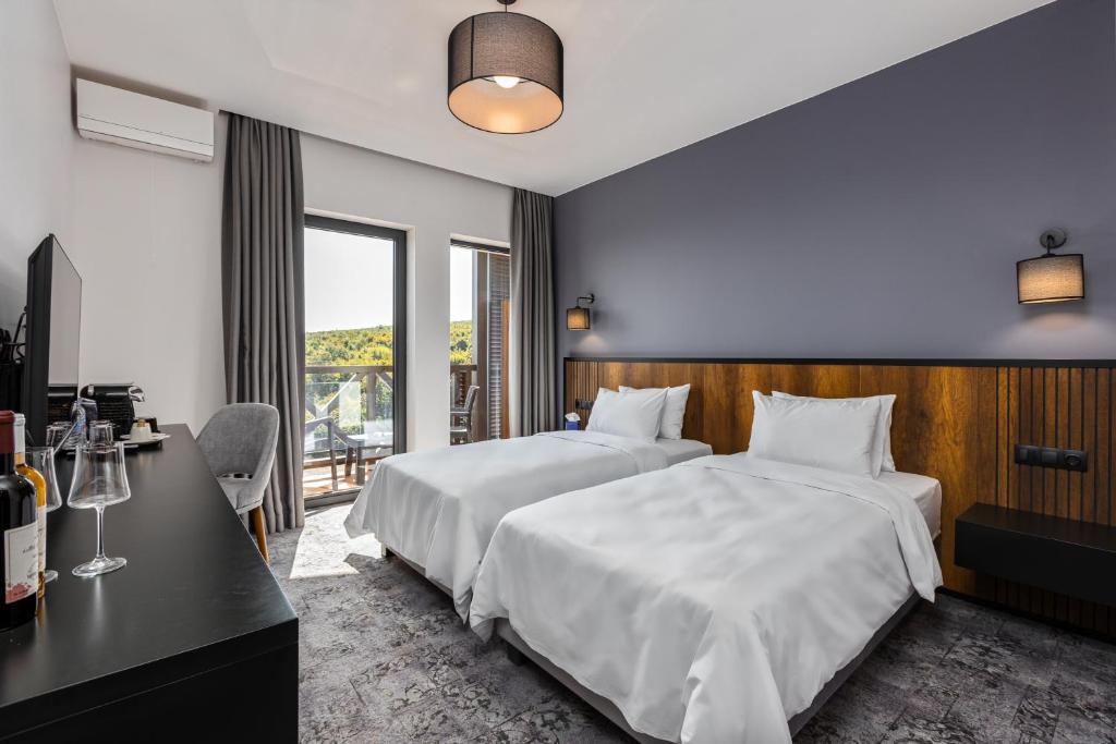 Postel nebo postele na pokoji v ubytování Hotel Qvevrebi