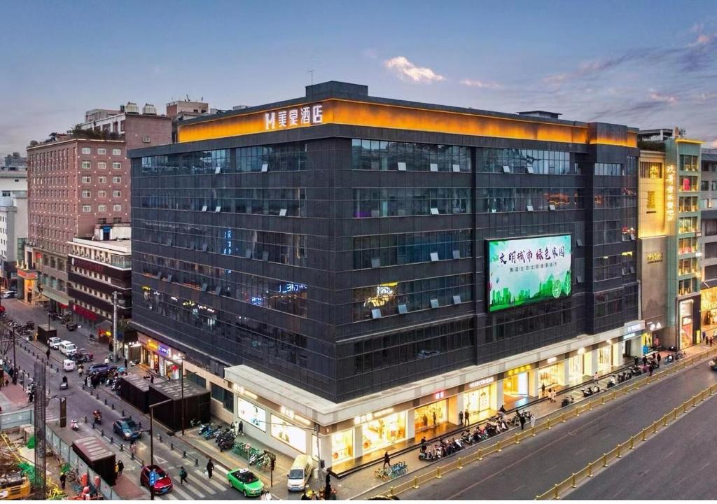 a large building with a sign on it on a city street at Mehood Theater Hotel, Zhonglou Metro Station Huimin Street in Xi'an