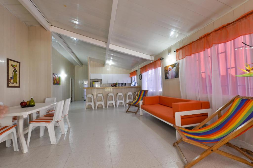 a living room with a couch and a table and chairs at Tropical Coral in San Andrés