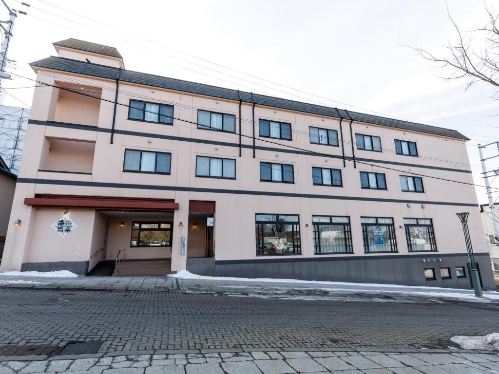 a large white building with a lot of windows at Tabist Hotel Nemuro Kaiyoutei in Nemuro