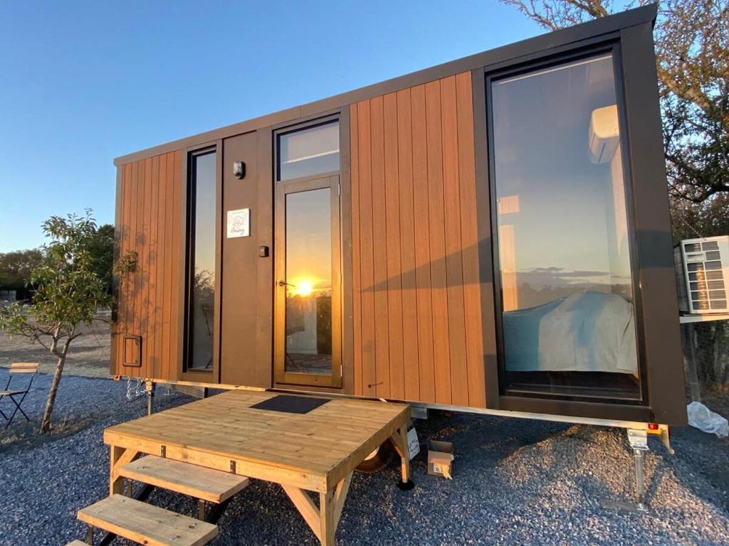 a tiny house sitting on a wooden platform at Longford Tiny Houses in Longford