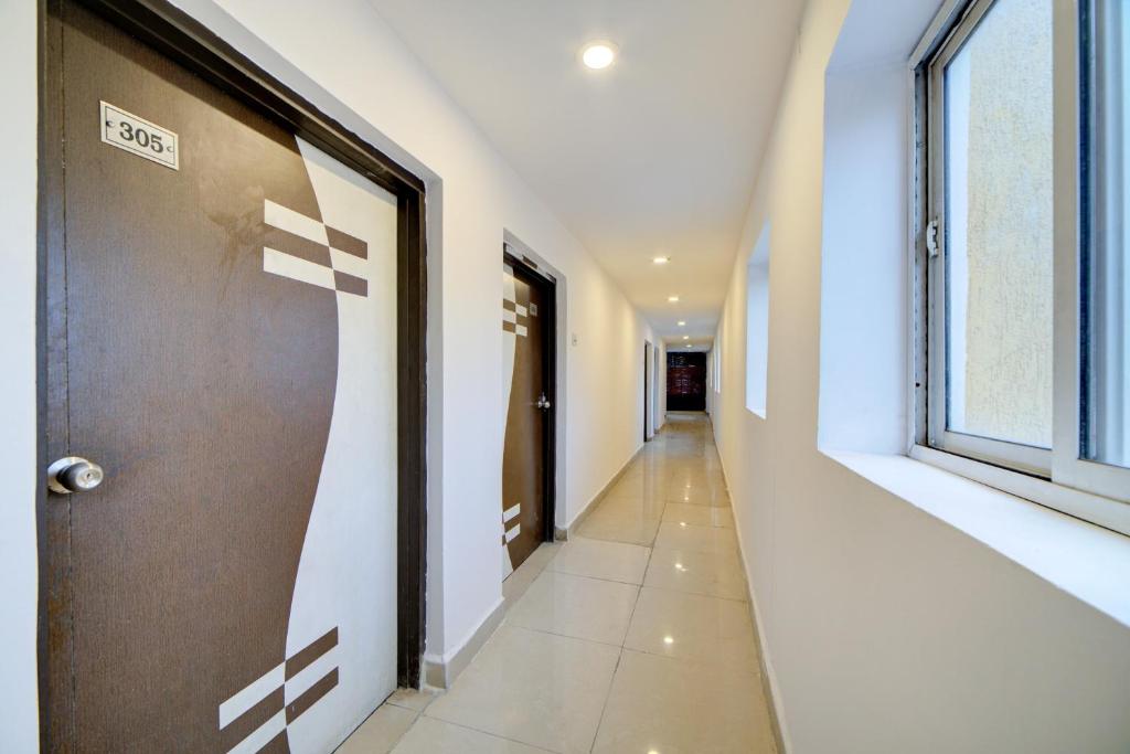 a hallway with a door and a window at OYO Flagship Hotel Hill Park Grand in Hyderabad