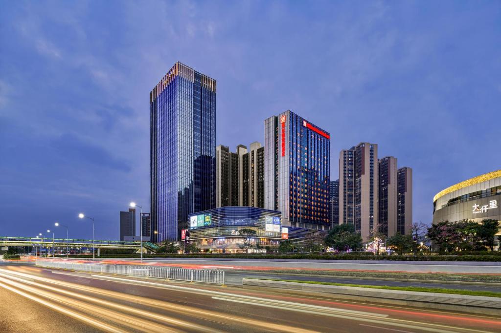 a city skyline with tall buildings and a freeway at Hilton Garden Inn Shenzhen Guangming in Shenzhen