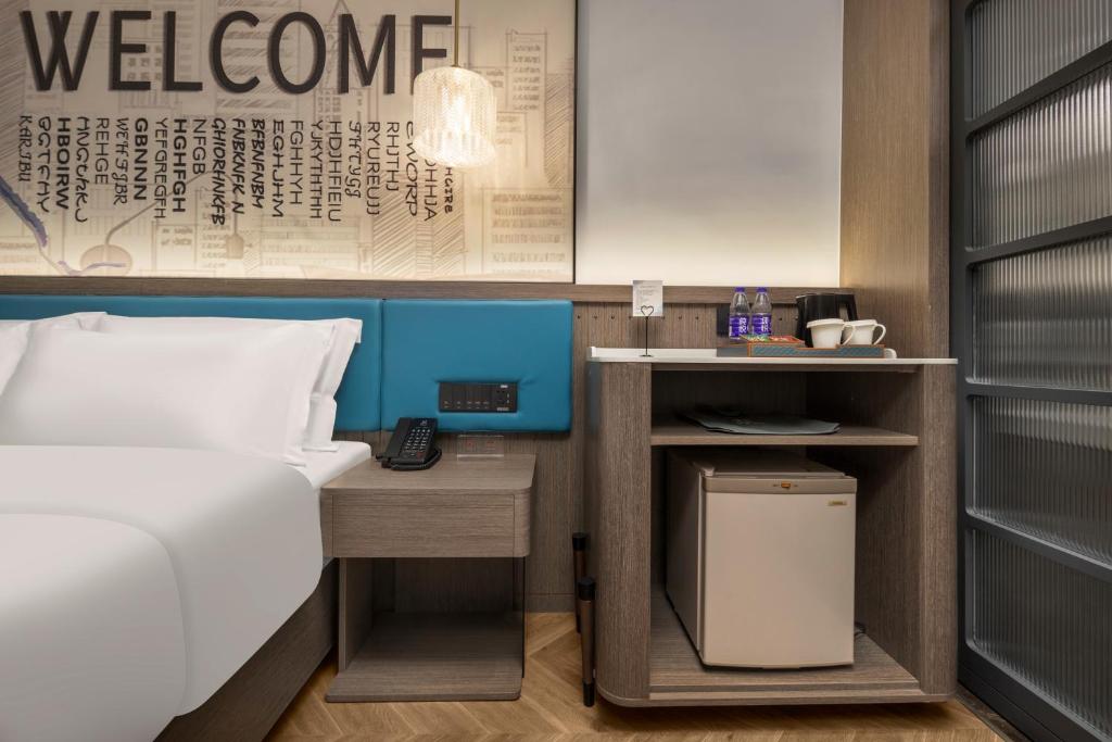 Postel nebo postele na pokoji v ubytování Mehood Hotel Huangshan High-Speed North Station