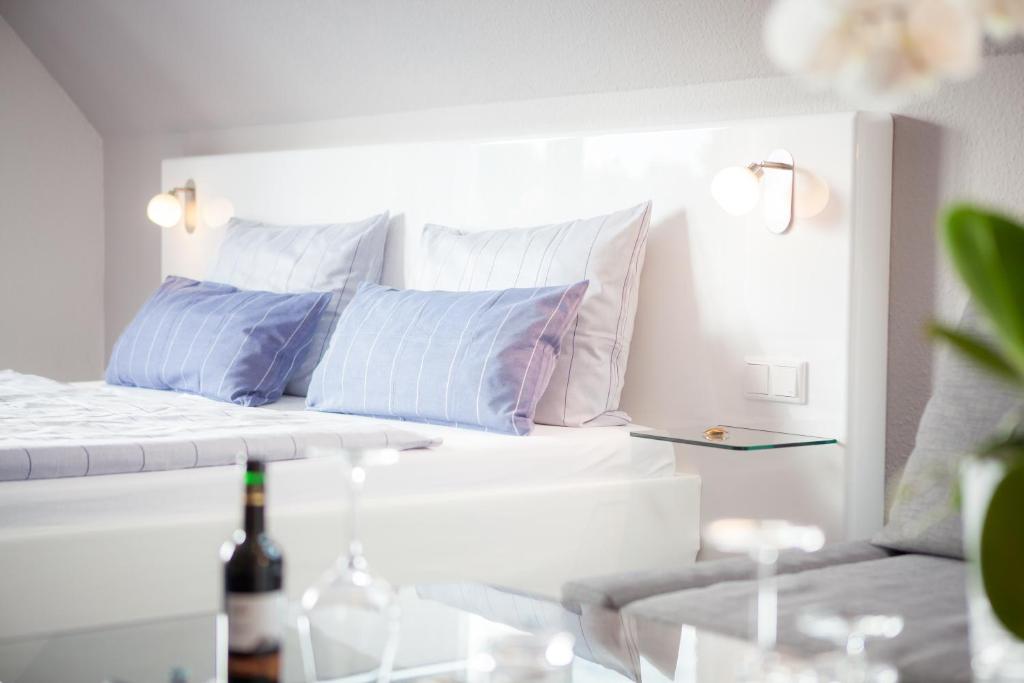 a bedroom with a bed with pillows and a table at Hotel zur Bever in Telgte