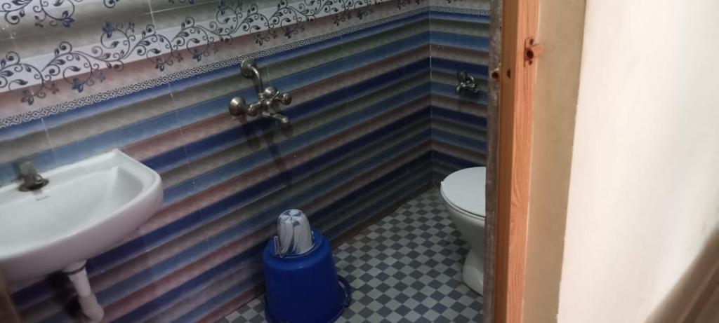 La salle de bains est pourvue d'un lavabo et de toilettes. dans l'établissement Hotel Aadhitiya, à Kāraikkudi