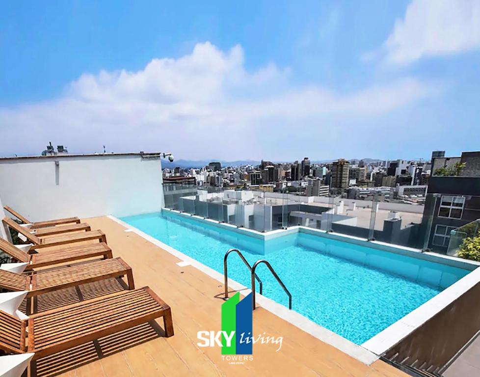 a swimming pool on the roof of a building at Skyliving Towers Apartments - Perú in Lima