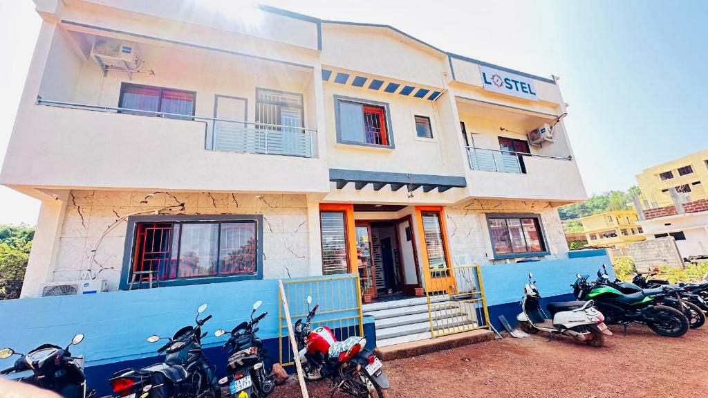 a group of motorcycles parked in front of a building at Lostel - Backpacker Hostel in Gokarna
