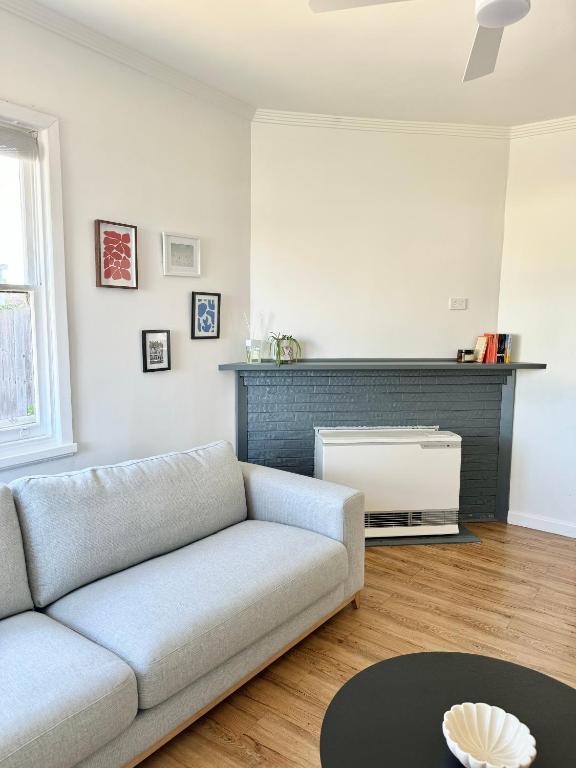a living room with a couch and a fireplace at No. 231 Waterfront in Portland