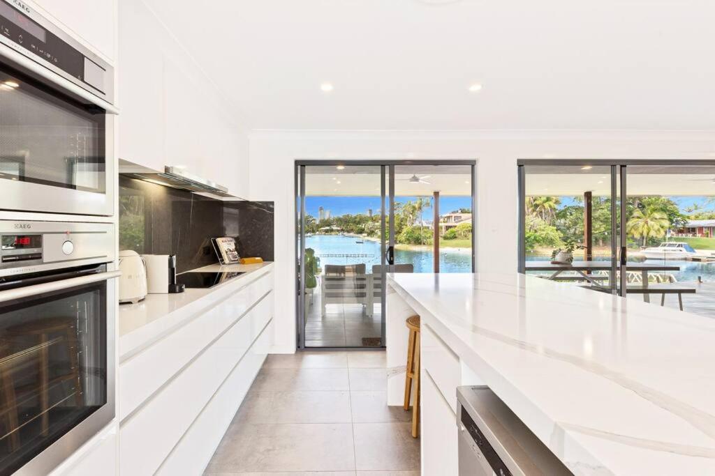 a white kitchen with a view of the ocean at Broadbeach Waterfront home with pool in Gold Coast