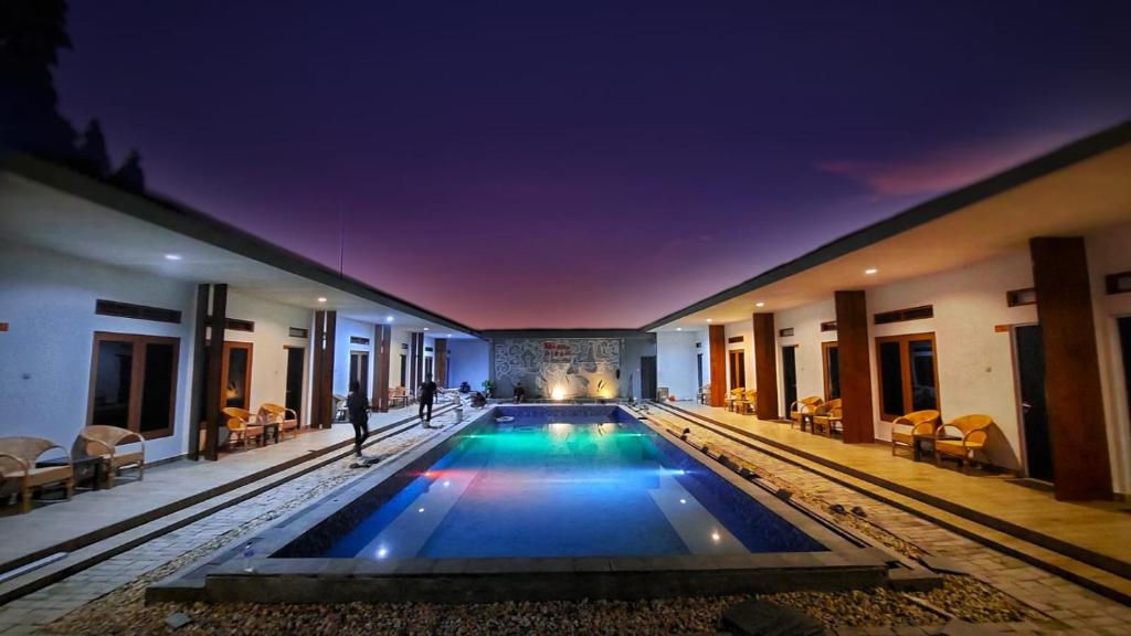 a large swimming pool in a building at night at Morika Inn in Waikabubak