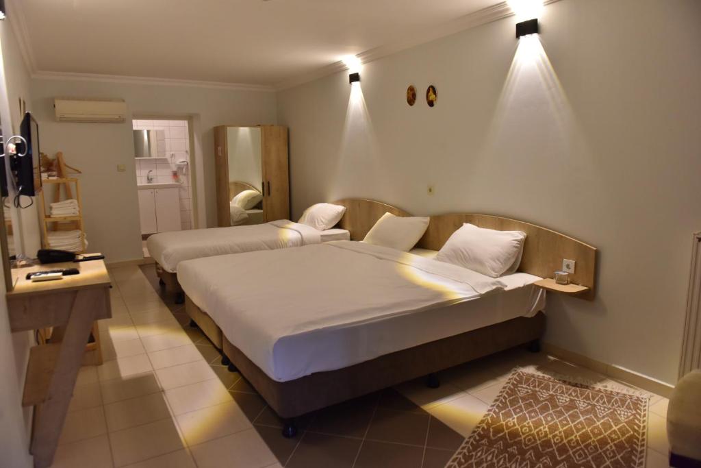 a hotel room with two beds and a mirror at Hermes Country Club in Beykoz