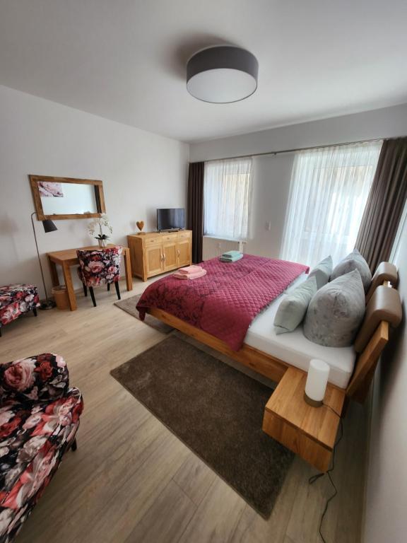 a bedroom with a large bed and a desk at Heine`s Hof in Oschersleben