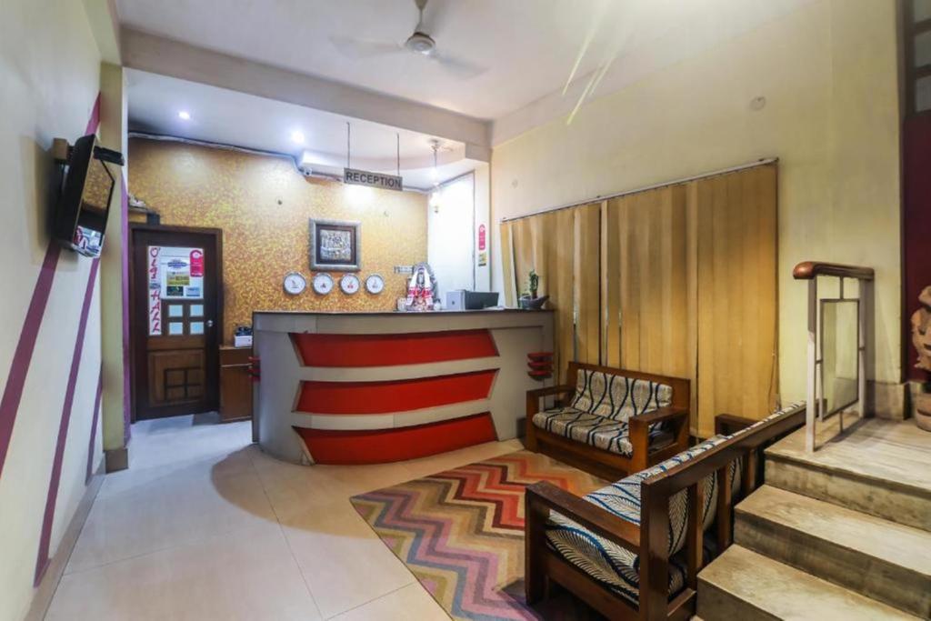 a lobby with a bar with a couch and a counter at Hotel YSM Grand in Tezpur