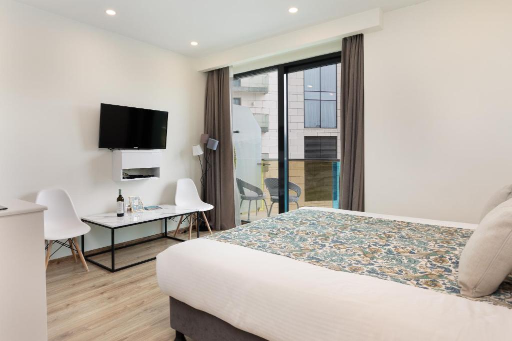 TV a/nebo společenská místnost v ubytování Bellevue Residence Suites