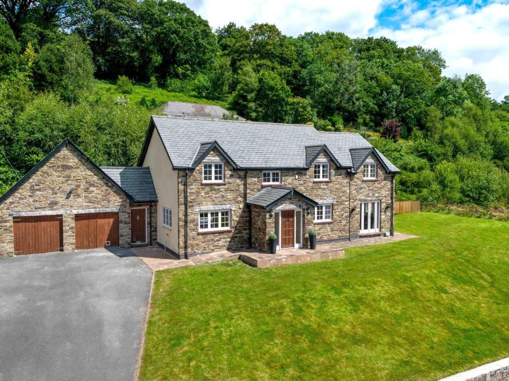 a large stone house with a garage at 5 Bed in Bwlch BN318 in Bwlch