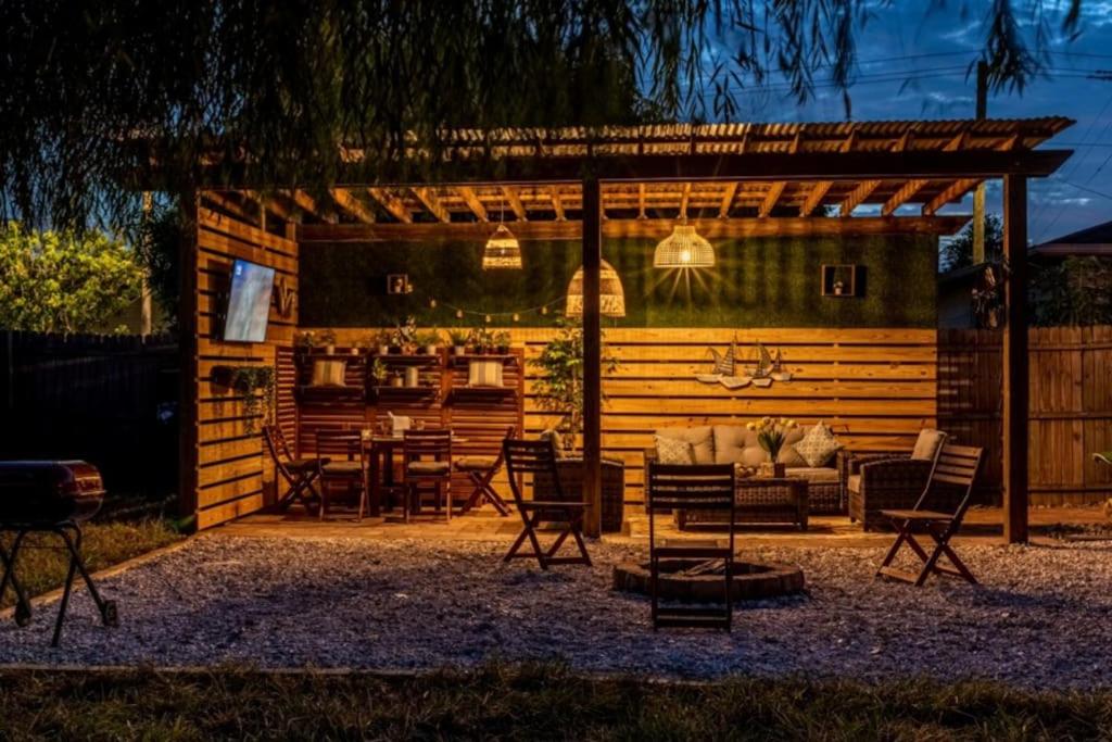 a pavilion with a table and chairs in a backyard at Upscale Ybor House with Outdoor Living Space in Tampa