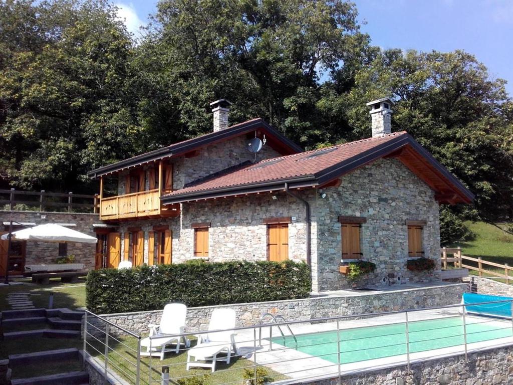 a house with a pool in front of it at La Dolce Vita chalet in Massino Visconti