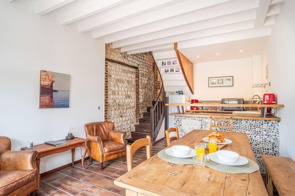 a living room with a wooden table and chairs at La Bicoque - Maison de pêcheur - Cour ext in Étretat