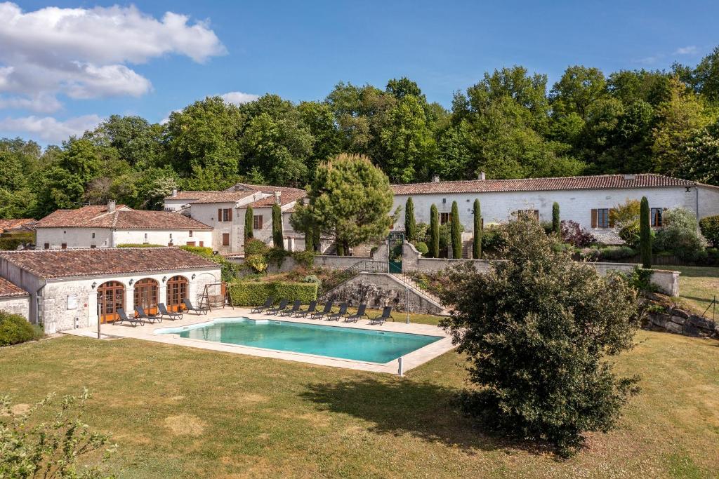 un domaine avec une piscine dans une cour dans l'établissement Le Relais de Saint-Preuil, The Originals Relais (Relais du Silence), à Saint-Preuil