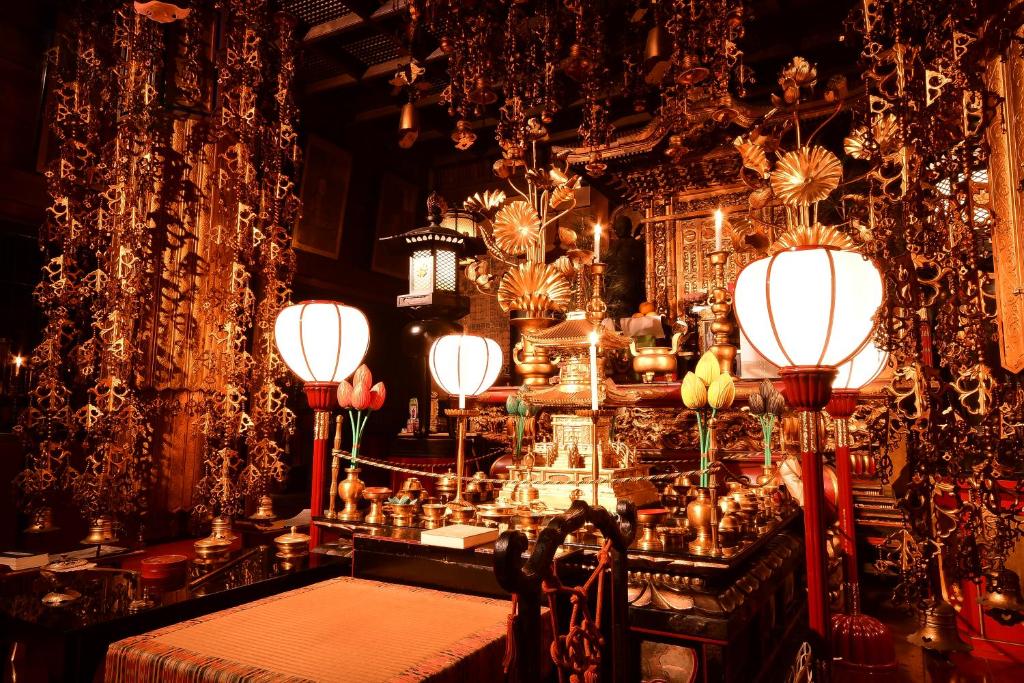 a dining room with a table and chandelier at 高野山 宿坊 桜池院 -Koyasan Shukubo Yochiin- in Koyasan