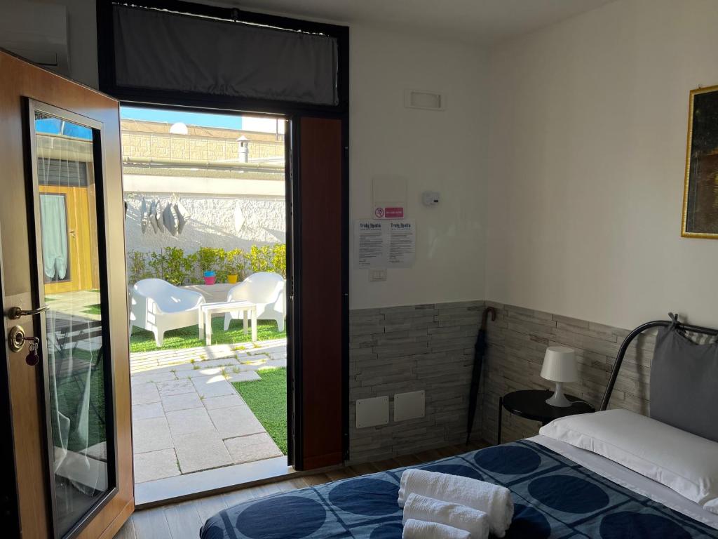a bedroom with a bed and a sliding glass door at Truly Apulia in Bari
