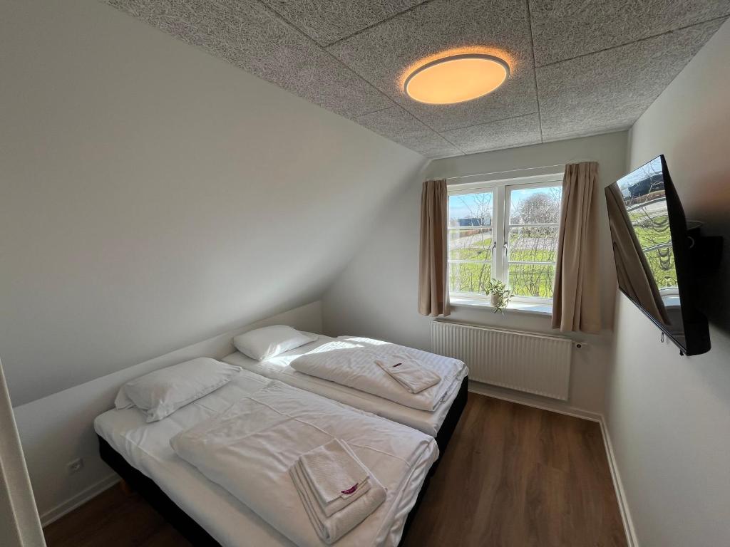 Postel nebo postele na pokoji v ubytování Go-Sleep Bredehus