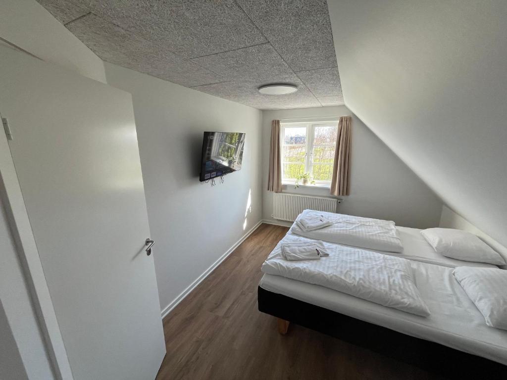 Postel nebo postele na pokoji v ubytování Go-Sleep Bredehus