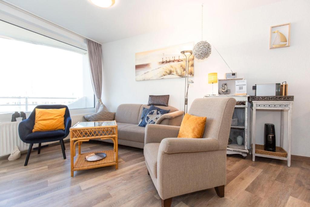 a living room with a couch and a chair at Lord Nelson 715 in Döse