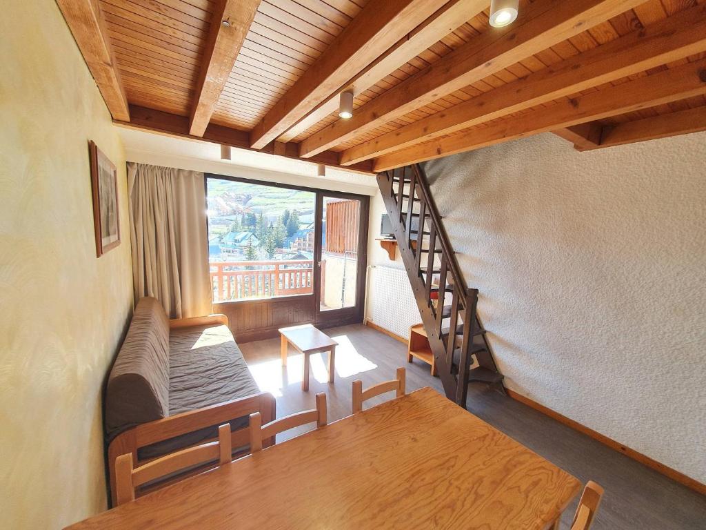a room with a dining room table and a staircase at Meijotel - 508 - Appart duplex - 6 pers in Les Deux Alpes
