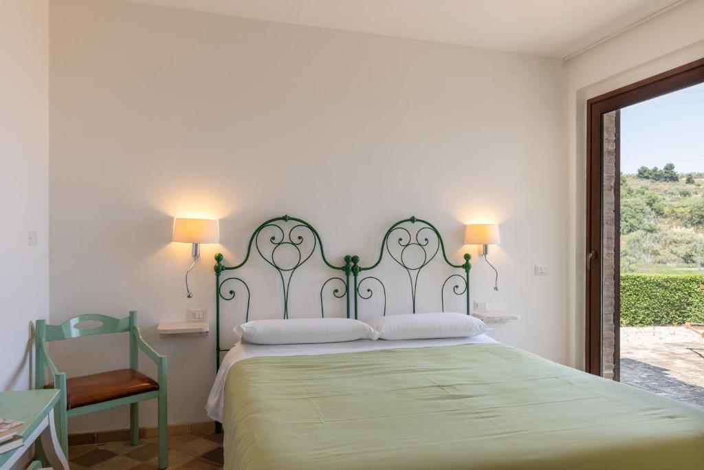 Łóżko lub łóżka w pokoju w obiekcie Villa Cri Cri B&B di Charme