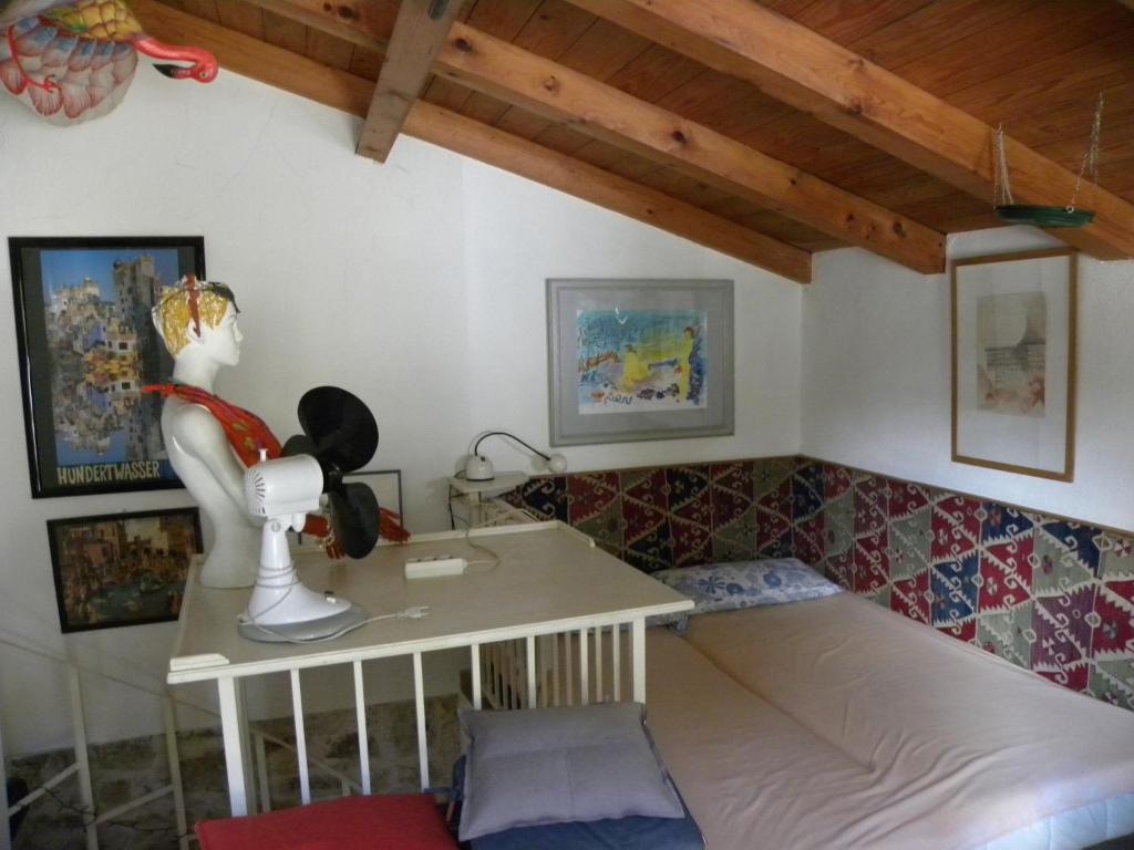 um quarto com uma cama e uma mesa com um boneco em Micha's Kuca em Porec