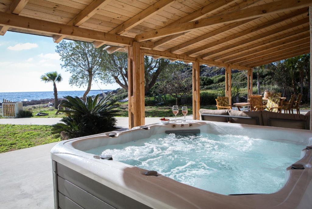 een jacuzzi in een paviljoen met uitzicht op de oceaan bij Mera Beachfront House - Falasarna in Falasarna