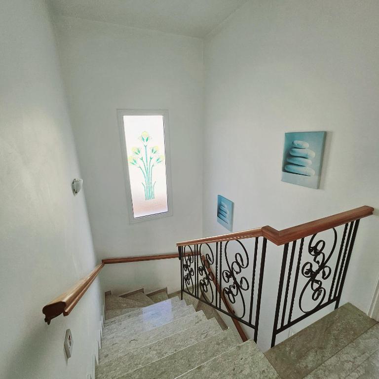 a room with a staircase with a window at Villa Athena in Peyia