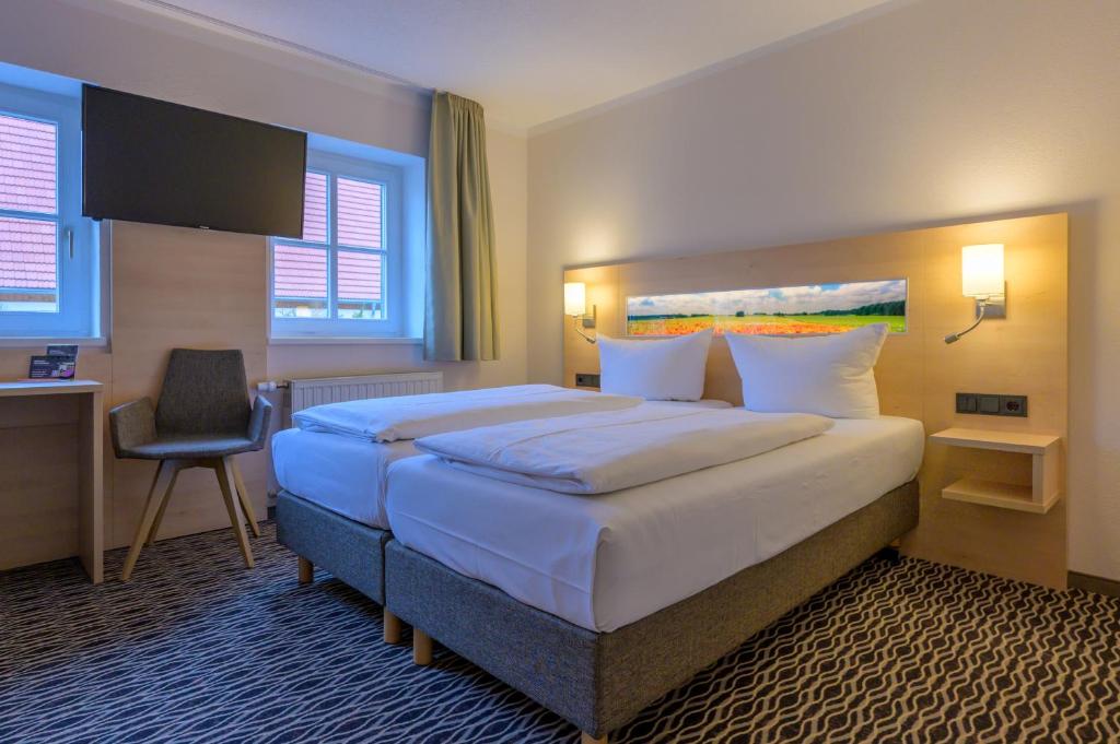 Postel nebo postele na pokoji v ubytování Hotel Maucksches Gut