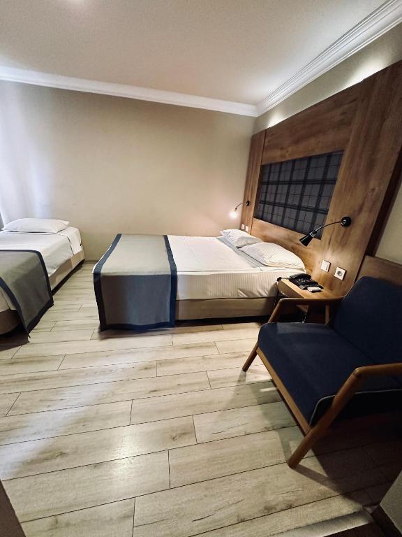 Postel nebo postele na pokoji v ubytování Laodikya Hotel