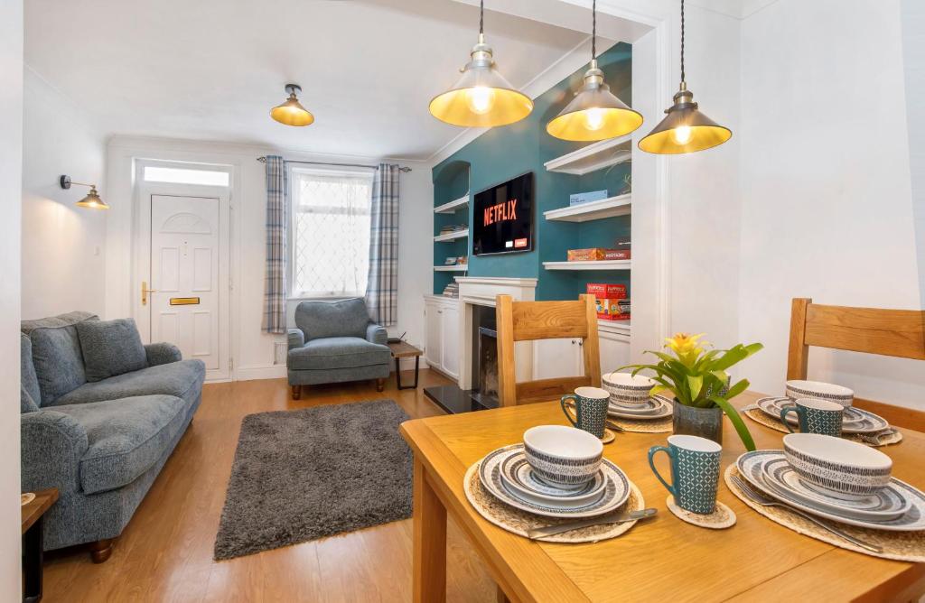 a living room with a table and a couch at House in Malton in Norton