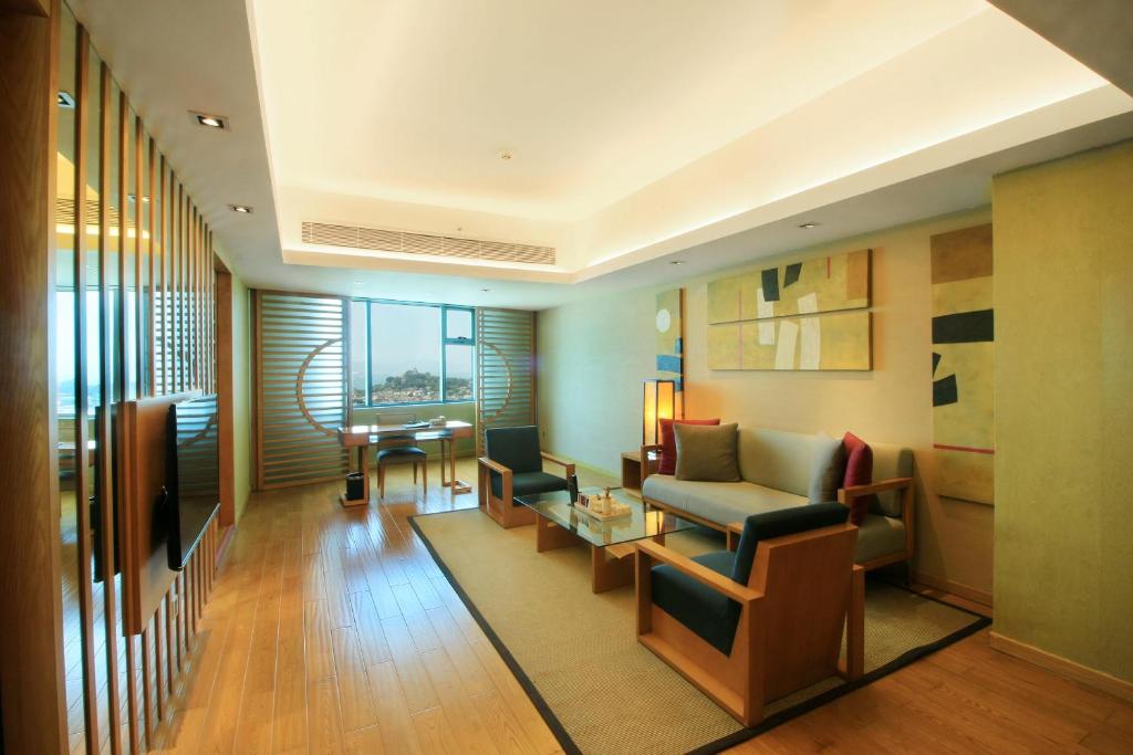 a living room with a couch and a table at Swiss Grand Xiamen-Harbour View in Xiamen