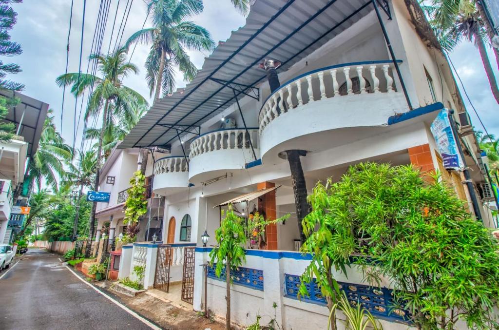 a house with a balcony on a street at Candolim beach touch flats in Candolim