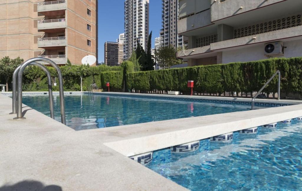 a swimming pool in the middle of a building at Mariscal V Alquilevante in Benidorm