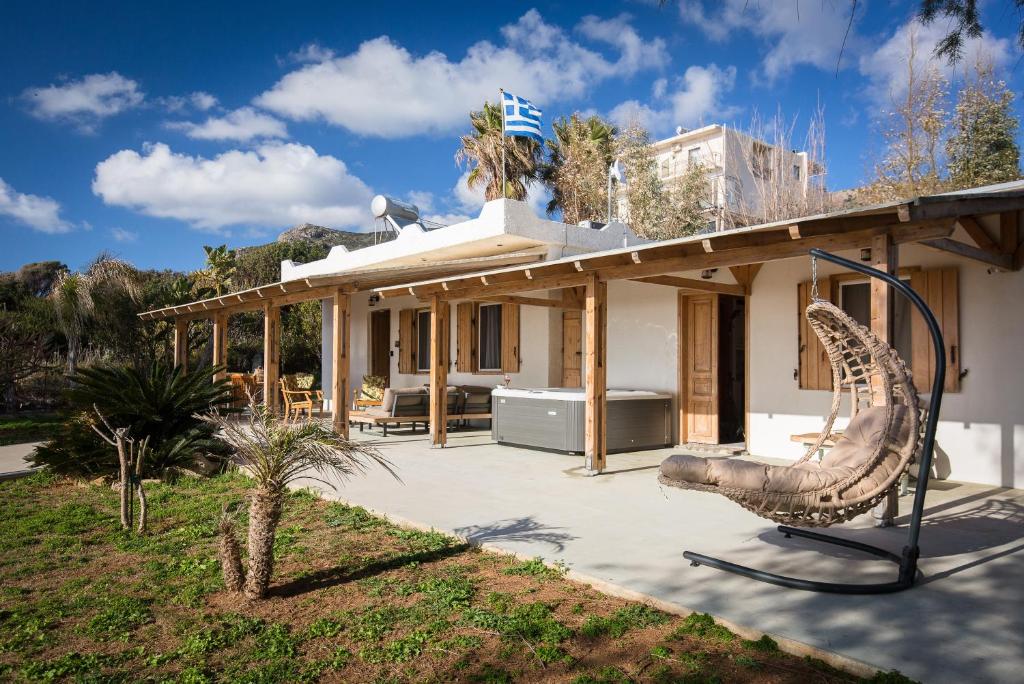 dom z placem zabaw przed nim w obiekcie Mera Beachfront House - Falasarna w mieście Falasarna