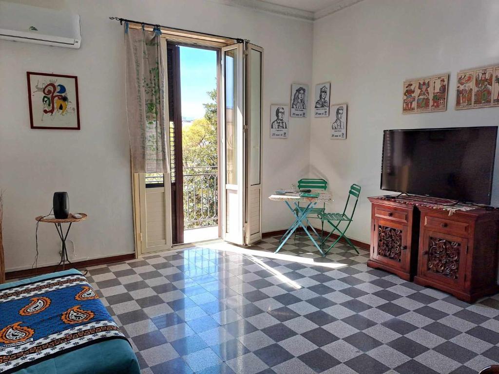 a living room with a television and a tiled floor at La casa sull'albero in Palermo