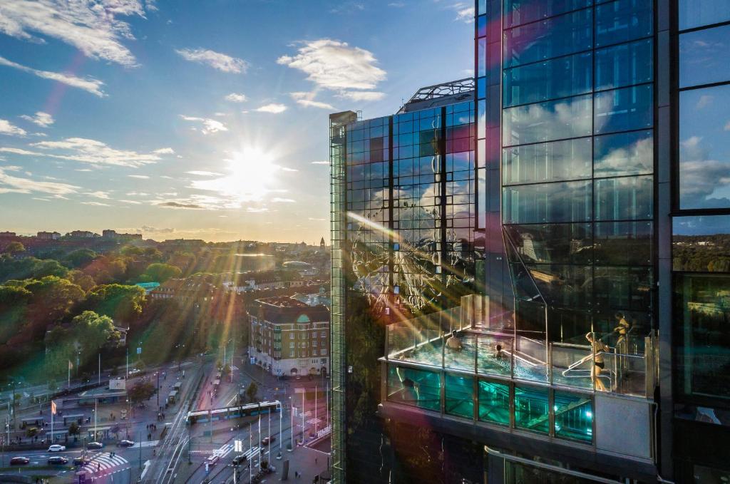 a tall glass building with a view of a city at Gothia Towers & Upper House in Gothenburg